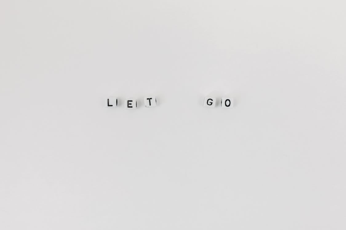 Free A Slogan Let Go Spelled with Letter Dice on White Background Stock Photo