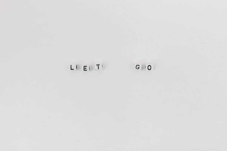 A Slogan Let Go Spelled With Letter Dice On White Background