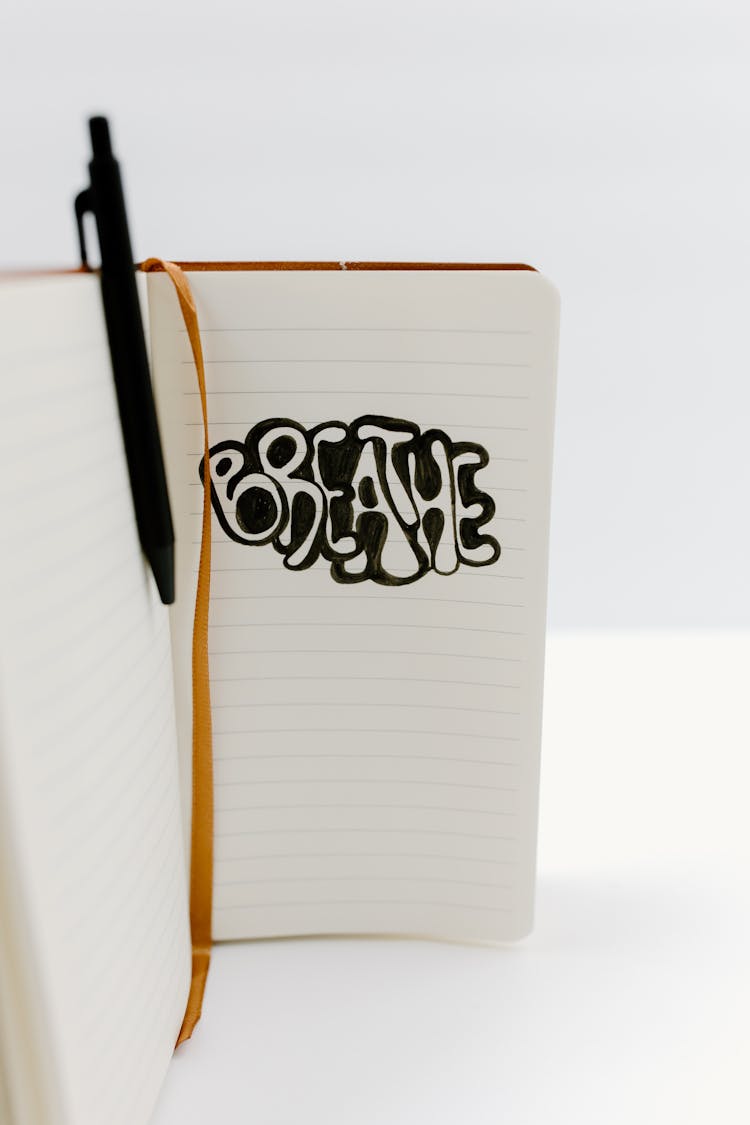 A Word Breathe Written On A Notebook
