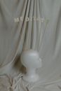 White Ceramic Figurine on White Textile