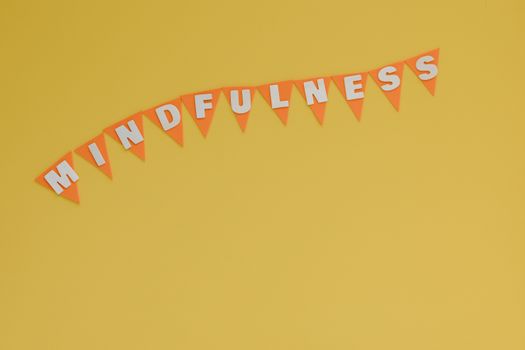 Banner with 'Mindfulness' on a bright yellow background, symbolizing calm and focus.