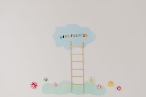 Free A minimalist conceptual art piece with a ladder leading to the word 'Mindfulness'. Stock Photo