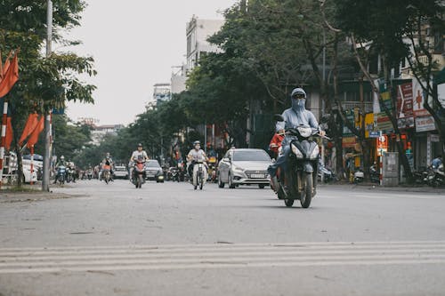 People Riding Motorcycles on Road
