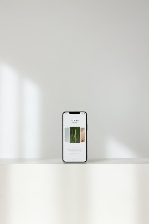 Modern Cellphone on Shelf on White Background