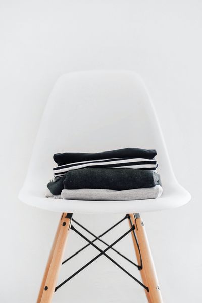 Neatly folded layers on a white chair — photo by Sarah Dorweiler on Pexels