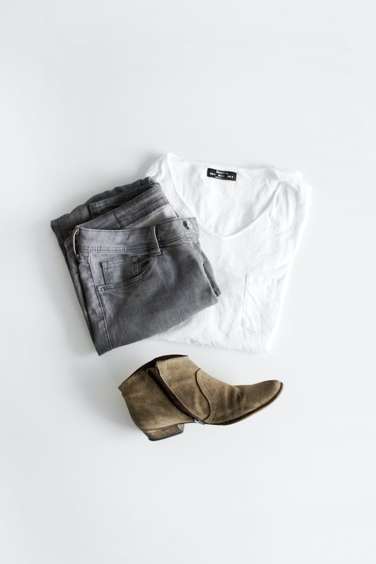 Clothes And A Boot On White Surface