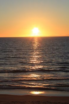 Capture the serene beauty of a sunrise over a calm sea, perfect for relaxation themes.