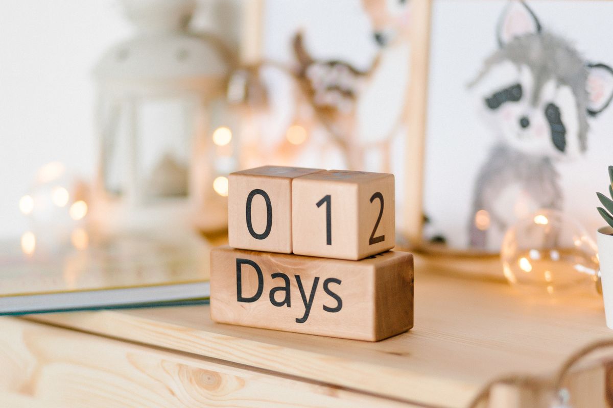 Hands writing on a wall calendar with a marker