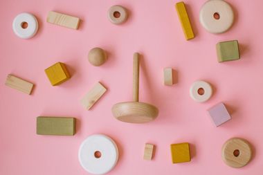 Wooden play blocks on pink, photo by Hanna Auramenka on Pexels