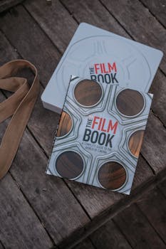 Exploring cinema: The Film Book placed artistically on a rustic wooden table.