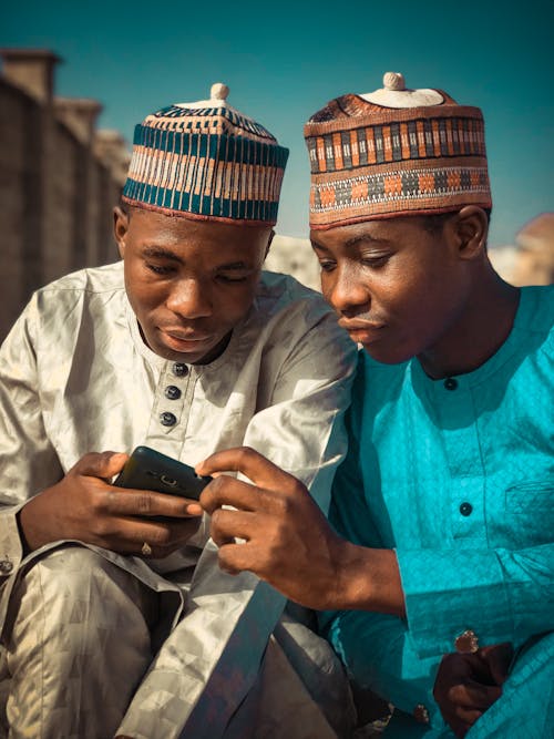 Free Men with Kufi Hats Looking at Smartphone Stock Photo