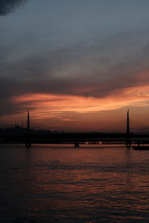 Free Stunning sunset view over a bridge in İstanbul, Türkiye, reflecting on the peaceful waters. Stock Photo