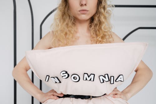 Free Woman Wearing a Pillow Using a Belt Stock Photo