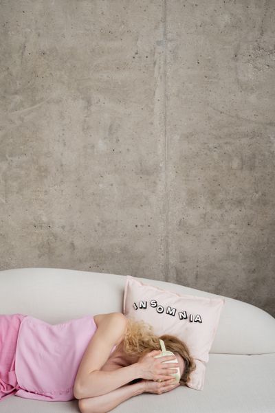 Person lying awake in bed — insomnia