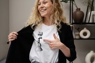 Smiling Woman in White Crew Neck Shirt and Black Cardigan