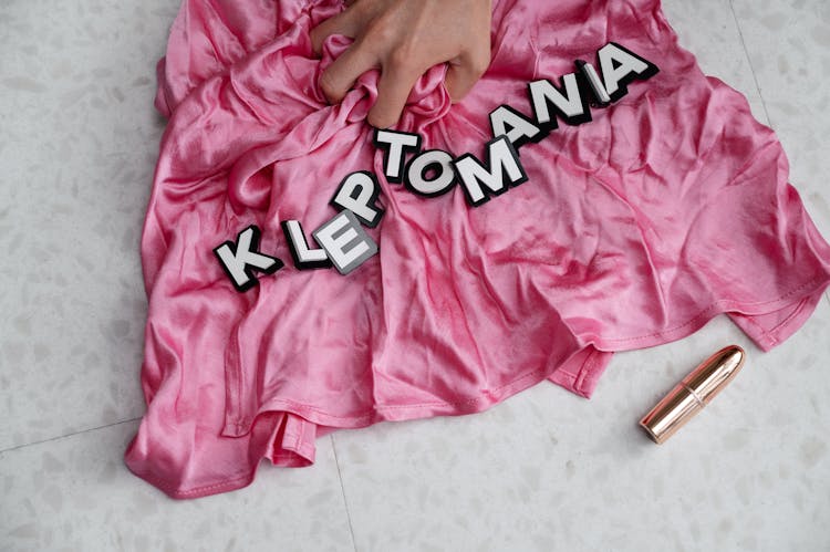 Letters On Top Of A Pink Fabric