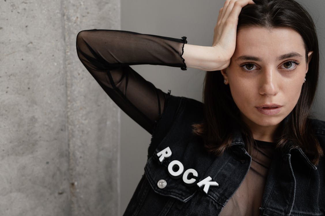 Woman in Black and White Crew Neck T-shirt Holding Her Hair