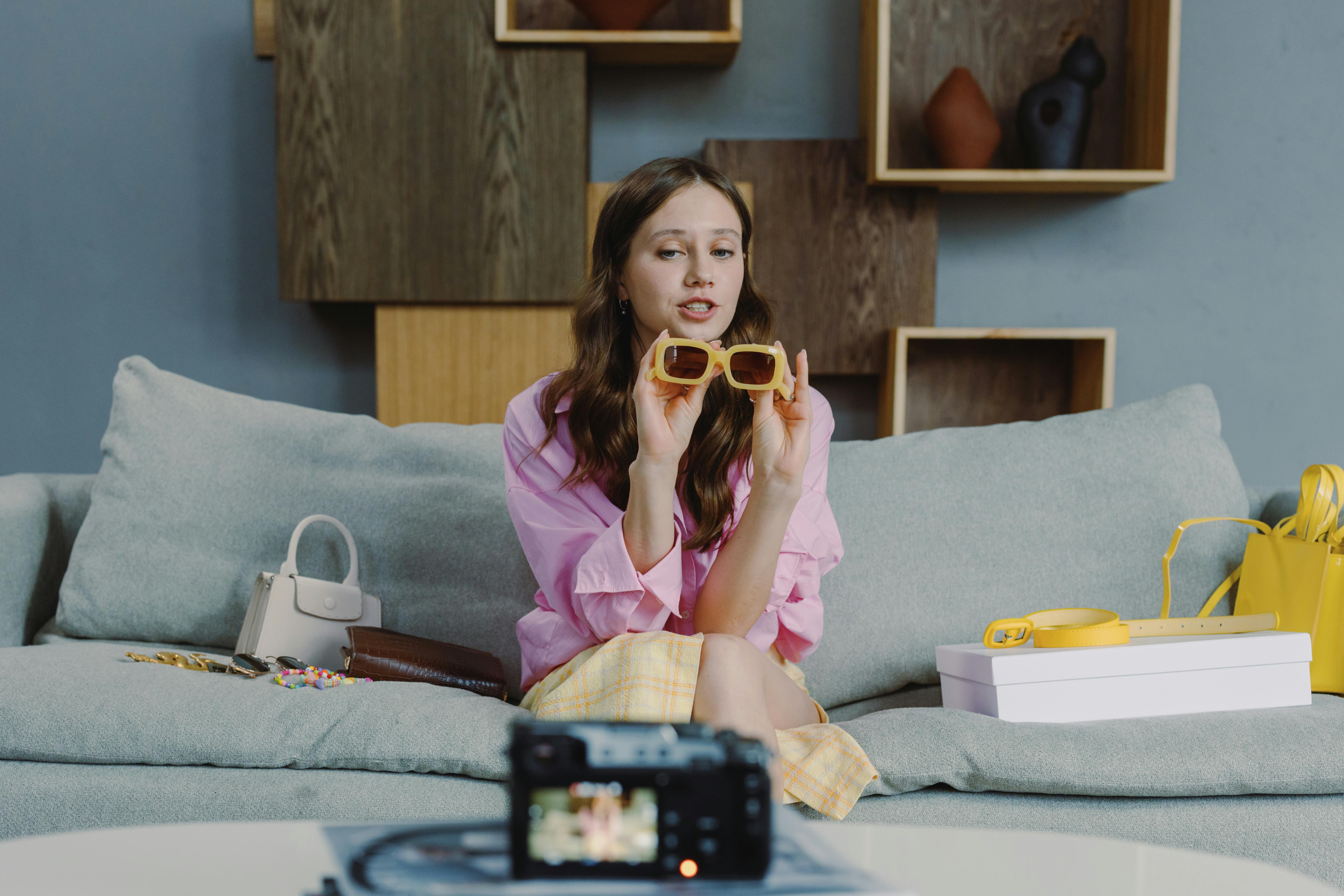 woman filming fashion unpacking on camera at home