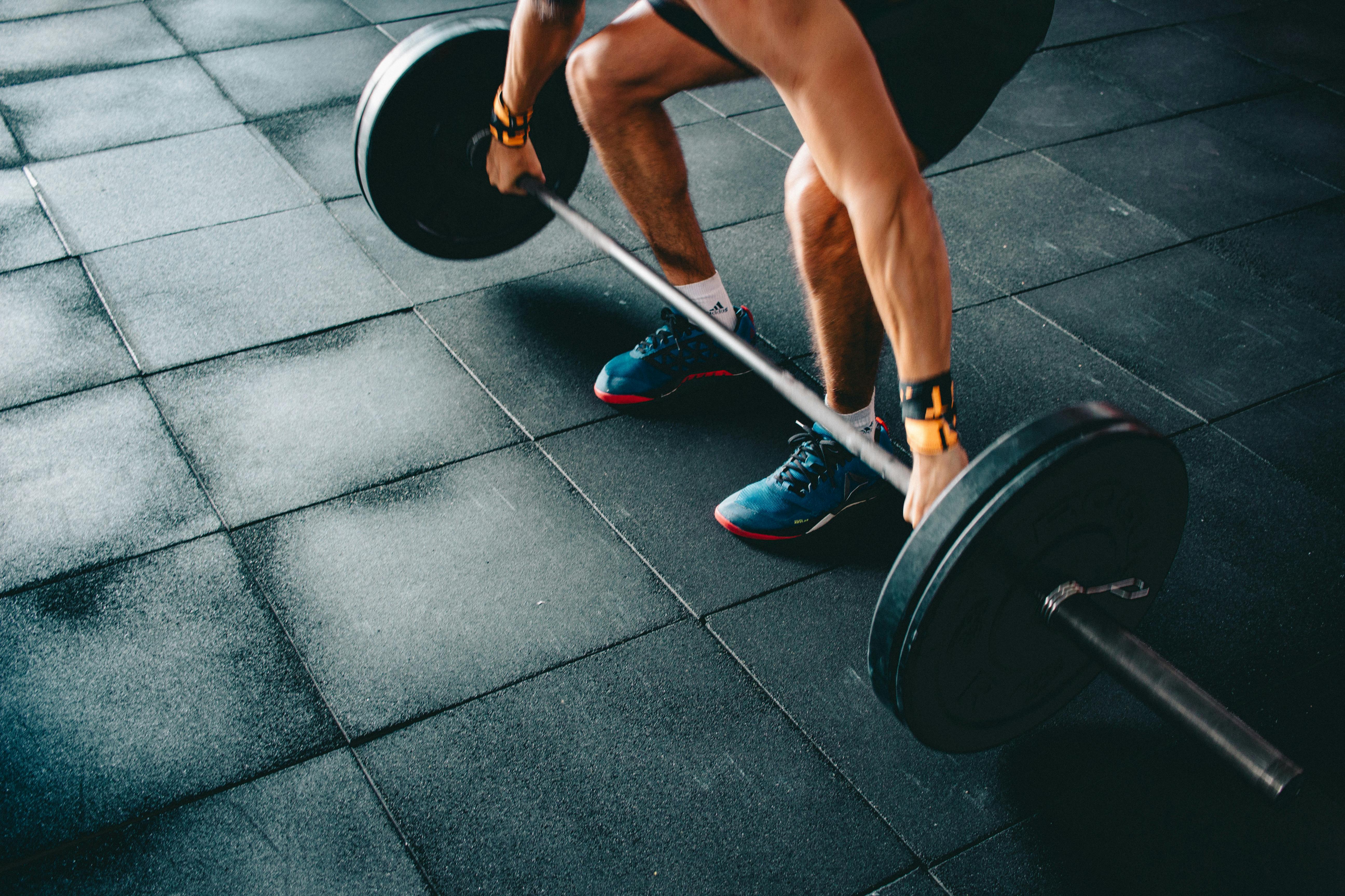 person holding barbell