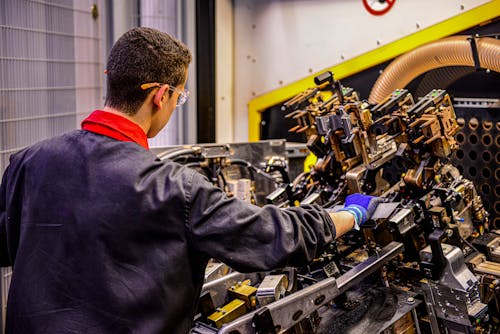 Backview of Man working on an Engine 