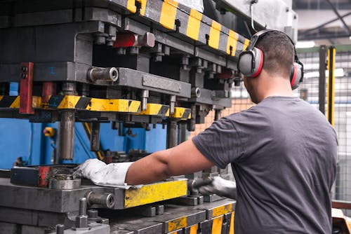 Worker with Hearing Protection in Factory