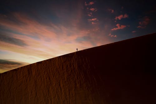 Person Standing on Brown Geological Formation 