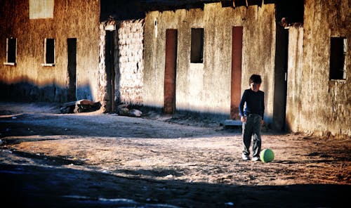 

A Boy Playing with a Ball