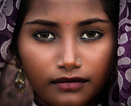 Close-up of a woman's face showcasing traditional beauty with vibrant details.