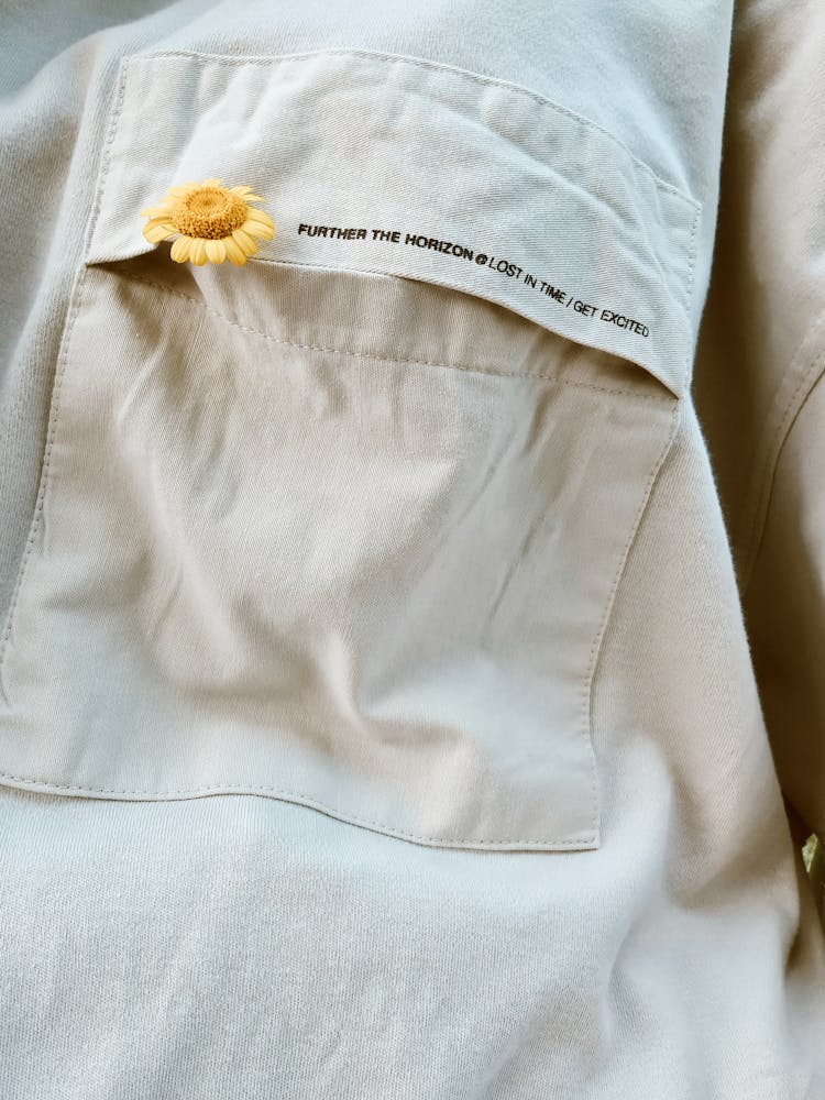 Close-up Photo Of Yellow Flower On A Polo's Pocket 