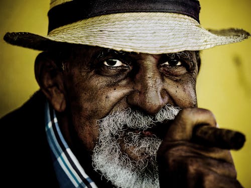 
An Elderly Man Smoking a Cigar
