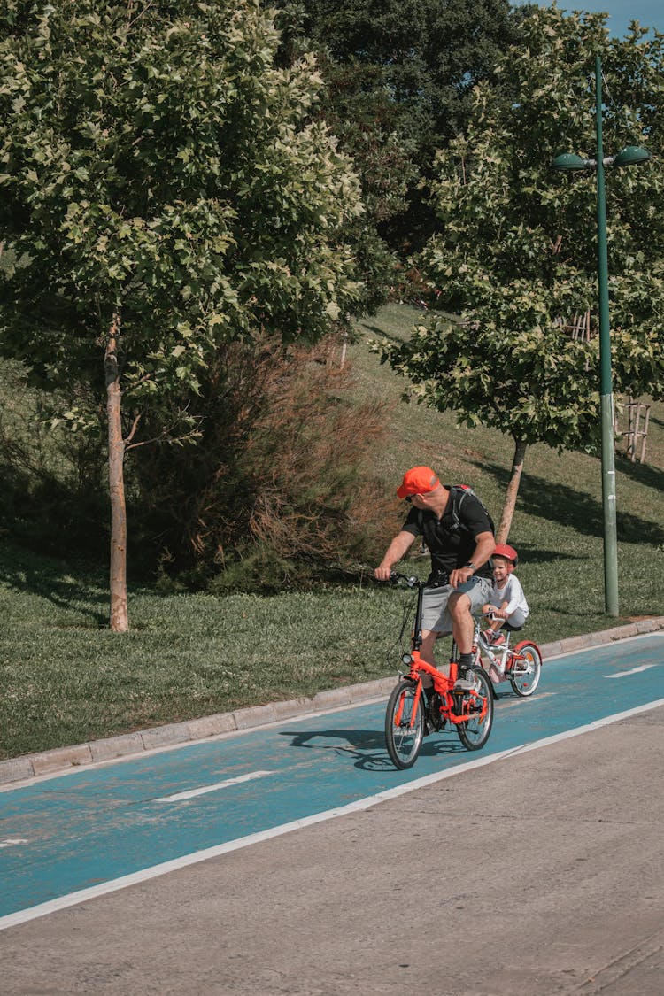 
A Father Riding A Bicycle With His Child 