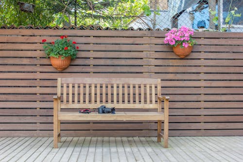Free  Wooden Bench Beside Brown Wood Fence Stock Photo