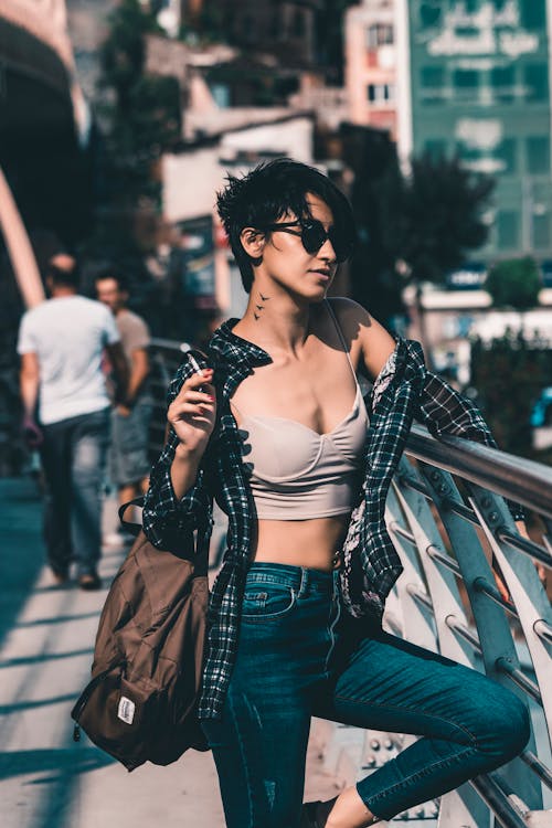 Woman Wearing a Crop Top Holding a Railing 