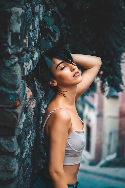 Woman in Gray Crop Top Near the Wall