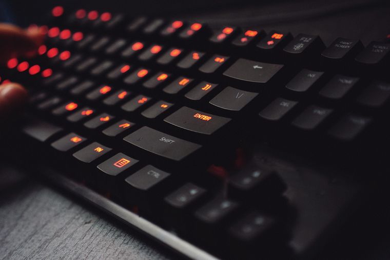 Backlit keyboard at a night desk — photo by Karol D on Pexels