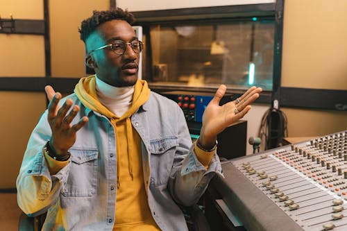 
A Man Wearing a Denim Jacket in a Studio