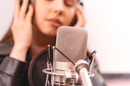 Free A Woman Singing on a Microphone Stock Photo