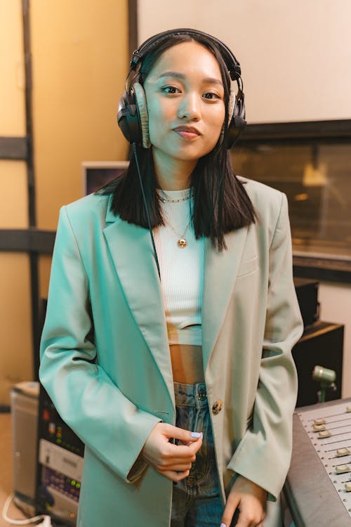 A Woman Wearing Headphones and a Blazer