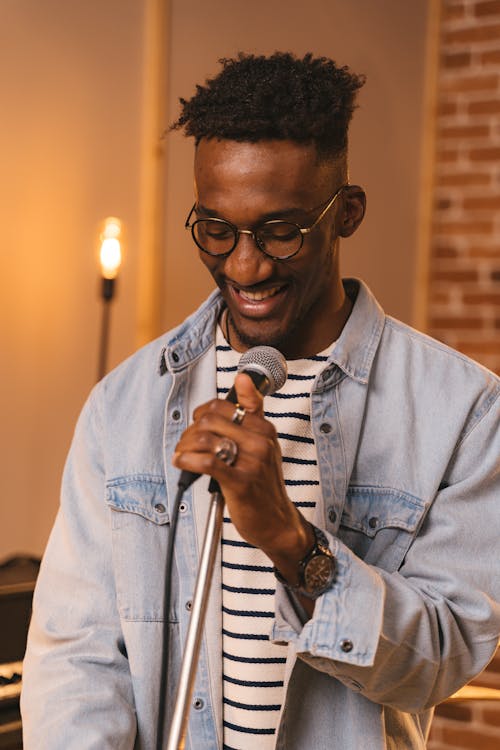 Man in Blue Dress Shirt Holding Microphone