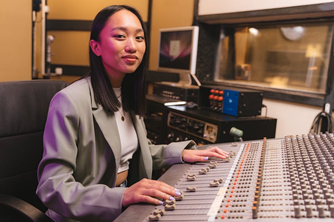 A Woman Using an Audio Mixer · Free Stock Photo