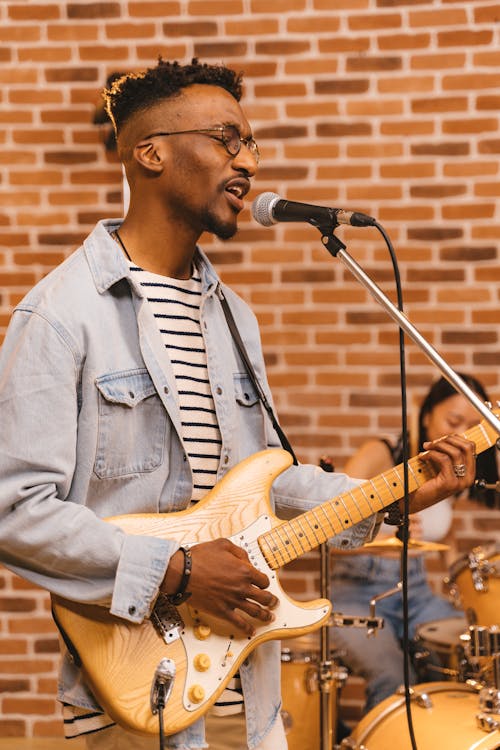 A Man Playing the Guitar while Singing