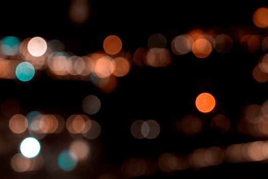 Abstract bokeh lights with a warm and vibrant glow against a dark background.