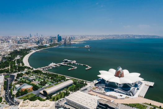 A captivating aerial view of Baku's skyline and coast, showcasing modern architecture and the Caspian Sea.