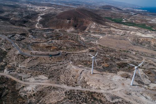 Free Stunning aerial view of wind turbines in a barren desert landscape, highlighting renewable energy. Stock Photo