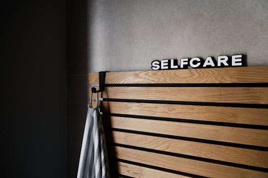 Wooden panel with 'Selfcare' sign hanging indoors, conveying a serene spa-like atmosphere.