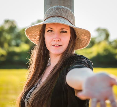 Woman in Black Shirt Wearing Brown Hat