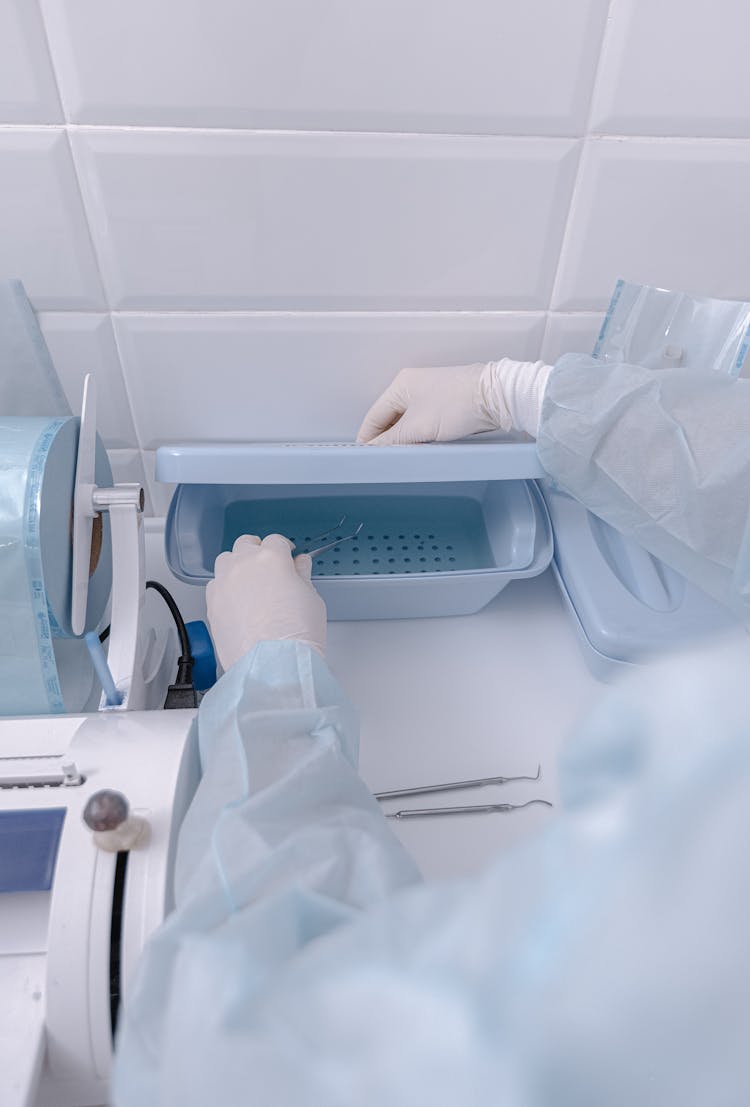 Doctor Opening Box With Vials In Lab