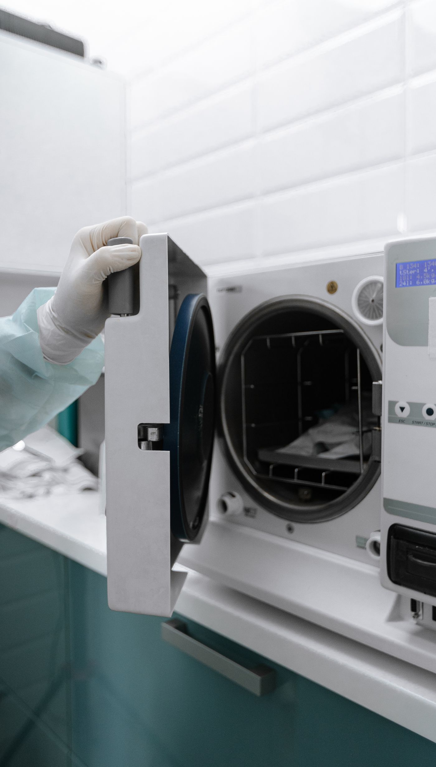 Professional opening a tabletop autoclave sterilisation machine