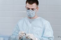 Man in White Dress Shirt Wearing White Face Mask