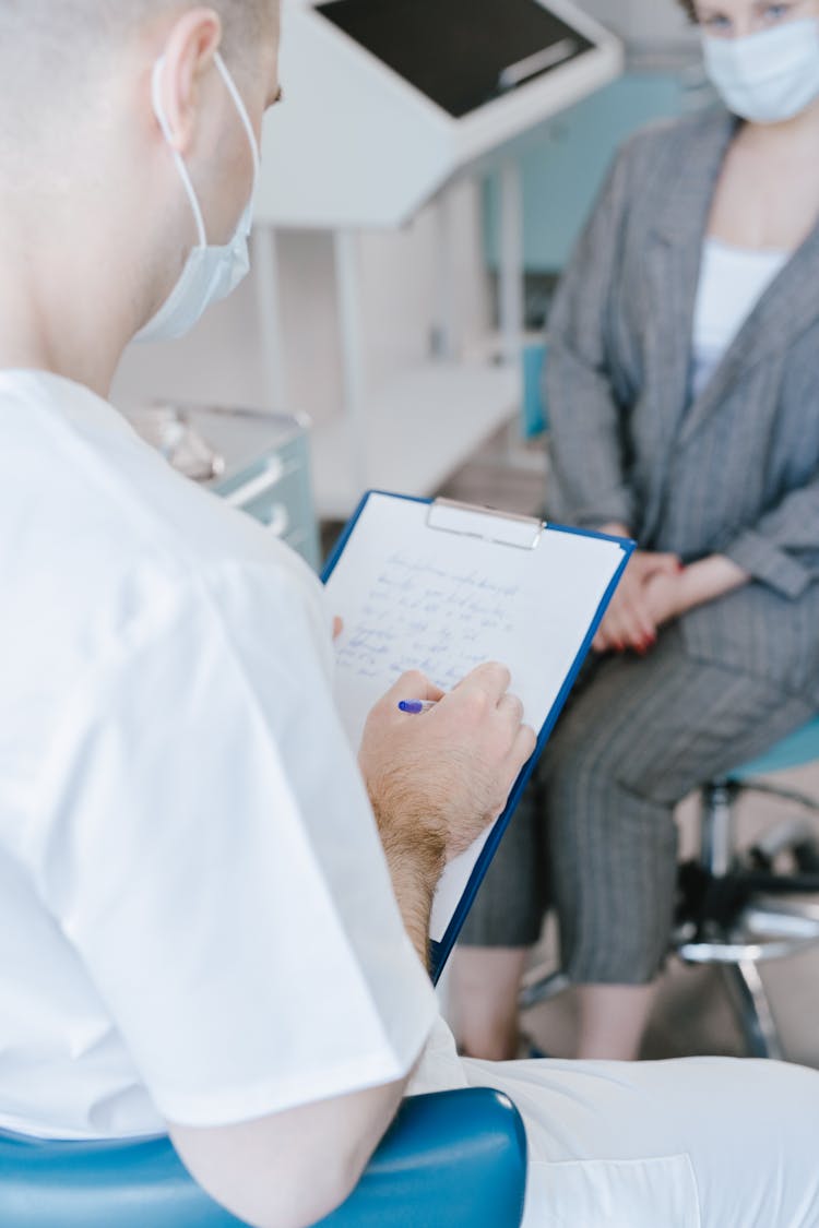 Doctor Writing On A Clipboard 